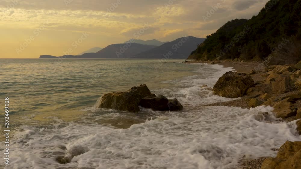 Fabulous seascape with rocky seashore splashed by waves at twilight with cloudy sky in Mediterranean Fabulous seascape with rocky seashore splashed by waves at twilight with cloudy sky in Mediterranean