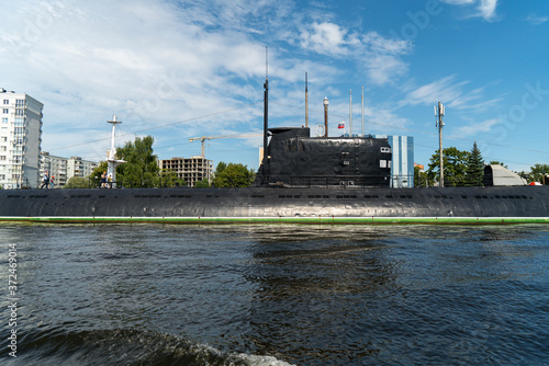 black submarine is parked in the port, central part of the boat photo