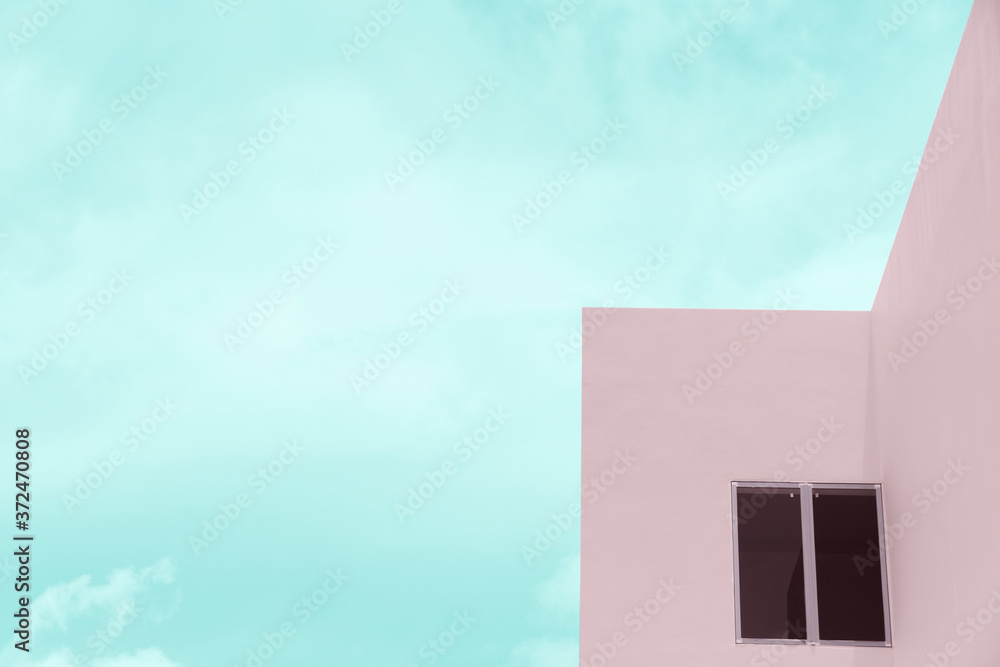 pastel pink cement building and window with blue cloud sky background