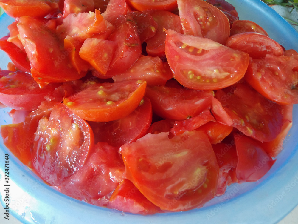 Sliced tomatoes in a bowl on the table Sliced tomatoes in a bowl on the table