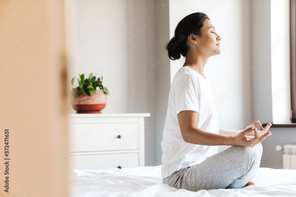 Young asian woman practicing yoga at the bedroom Young asian woman practicing yoga at the bedroom