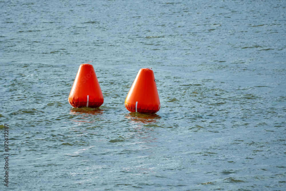 Inflatable orange buoys in a lake Inflatable orange buoys in a lake