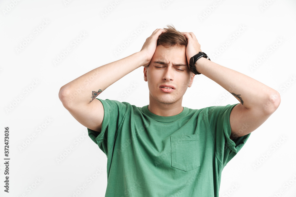 Image of dissatisfied caucasian man being stressed and grabbing his head Image of dissatisfied caucasian man being stressed and grabbing his head
