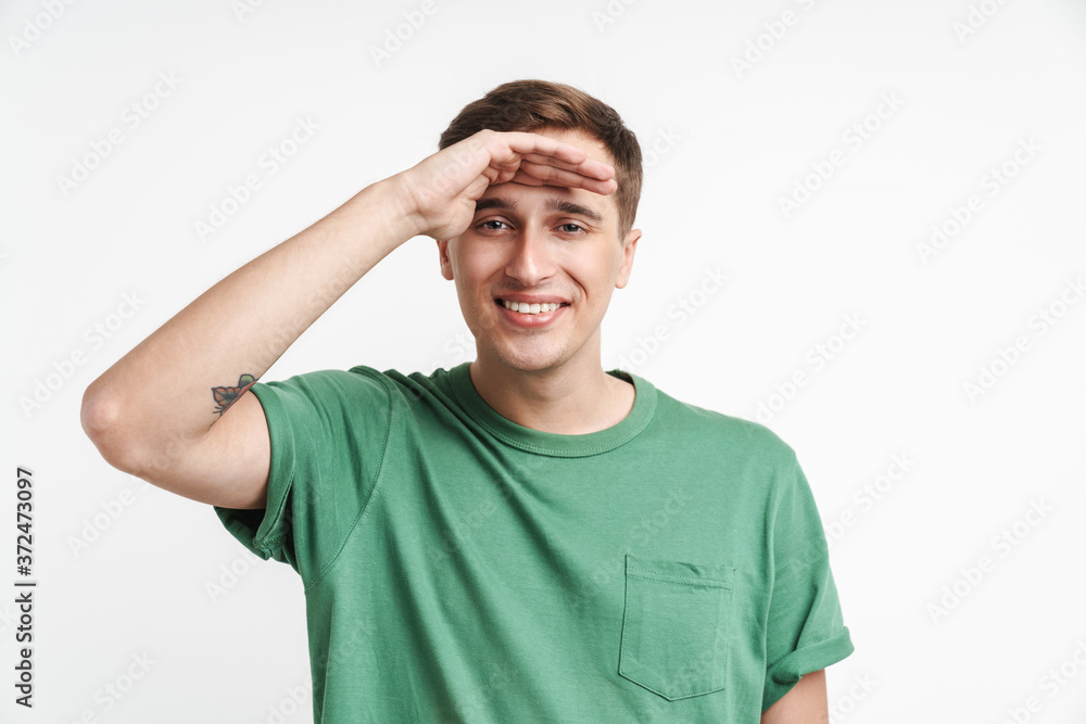 Image of young caucasian man looking far with hand at his forehead Image of young caucasian man looking far with hand at his forehead