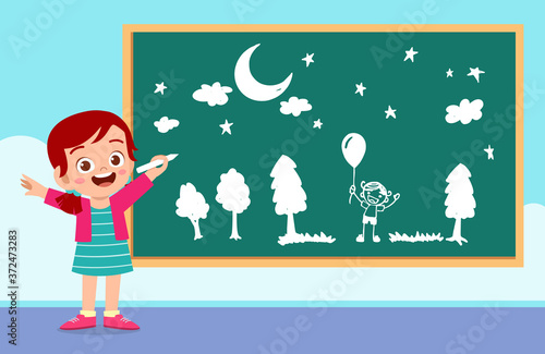 happy cute little kid boy and girl draw with chalk on blackboard together