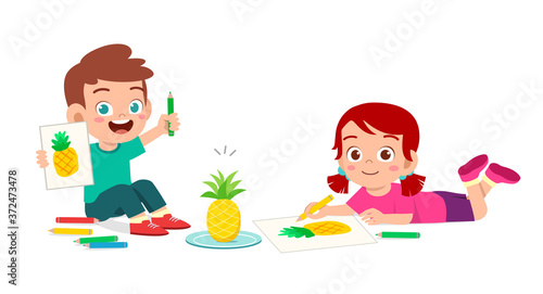 happy cute little kid boy and girl draw with crayon on paper