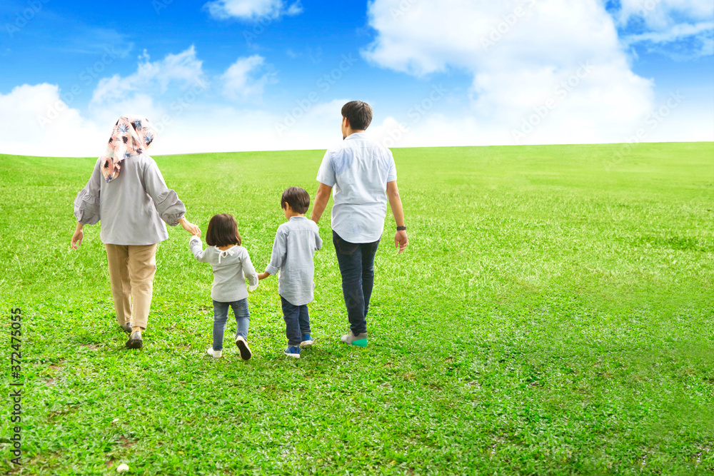 Happy family walking together at field Happy family walking together at field