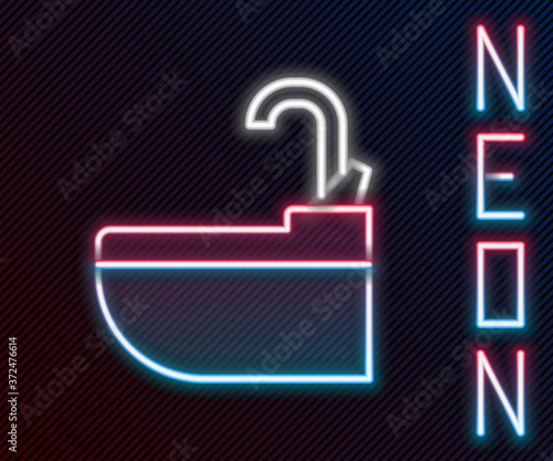 Glowing neon line Washbasin with water tap icon isolated on black background. Colorful outline concept. Vector Illustration.