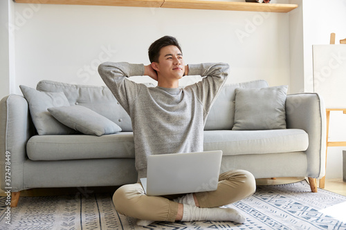 Photography happy young asian business man working at home using laptop computer