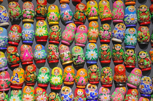 brightly coloured mini russian dolls on display board