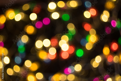 Defocused multicolored christmas lights background, bokeh. New year, holidays.