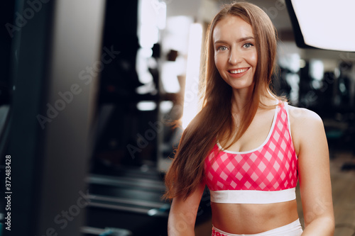 Young beautiful woman in sportswear in a gym Free Download Young beautiful woman in sportswear in a gym - GFXLoad