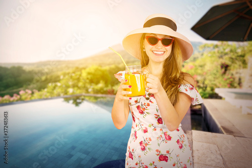 Young woman holding a glass of orange juice
