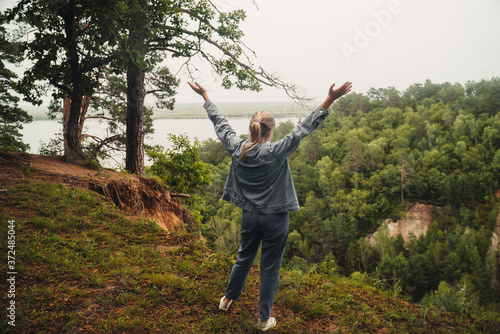 Young woman traveler conquered a high mountain. Summer Landscape