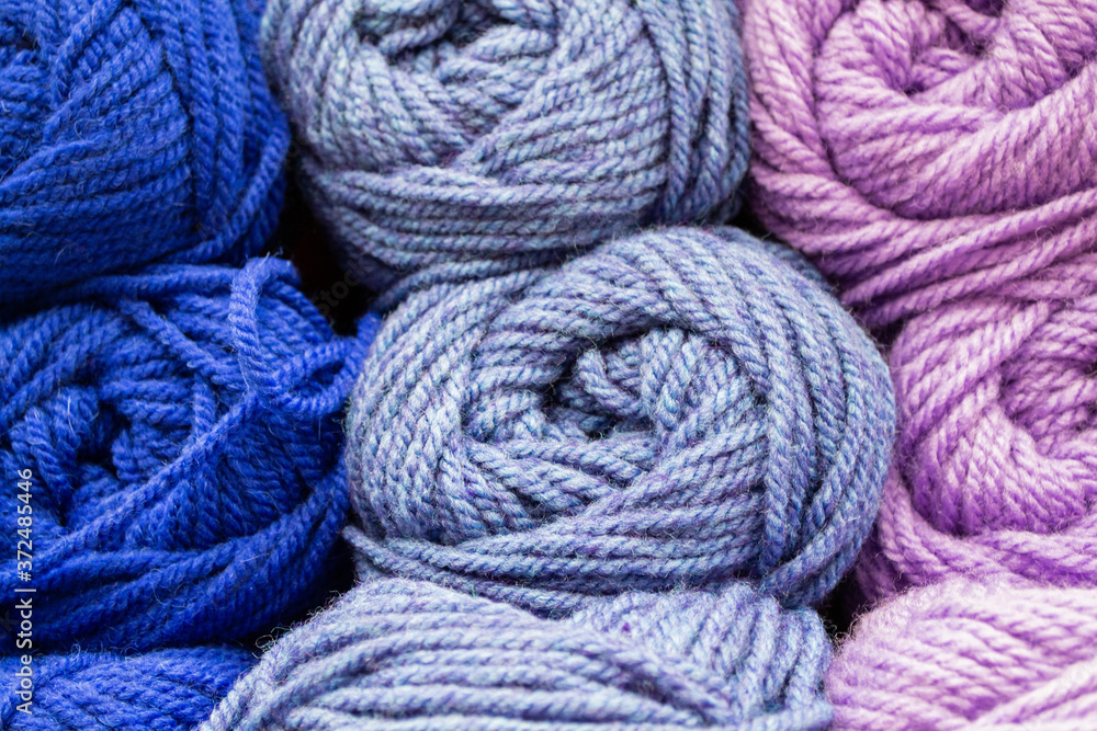 Close-up of skeins of thread in blue, lilac and pink pastel colors. Thread background Close-up of skeins of thread in blue, lilac and pink pastel colors. Thread background