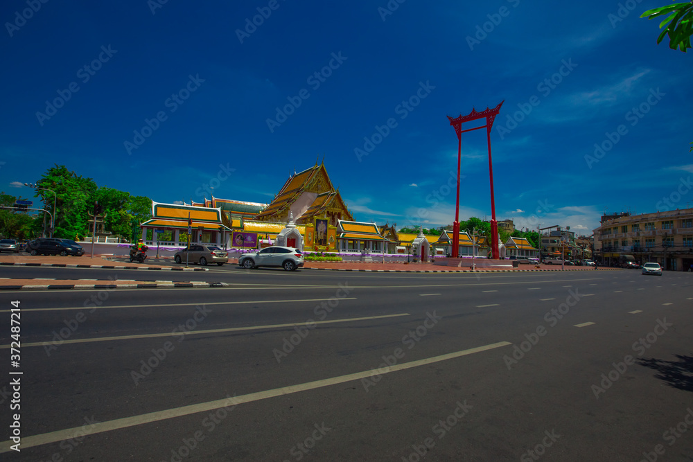 Background of one of the major tourist attractions in Bangkok(Wat Suthat Thepwararam)with beautiful churches and pagodas,popular people come to make merit and take pictures during holidays in Thailand Background of one of the major tourist attractions in Bangkok(Wat Suthat Thepwararam)with beautiful churches and pagodas,popular people come to make merit and take pictures during holidays in Thailand