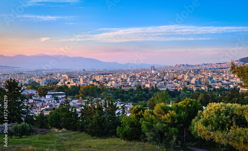 View of Athens and its residential areas from Pnyx hilltop in soft evening sunlight with great sunset sky © NPershaj
