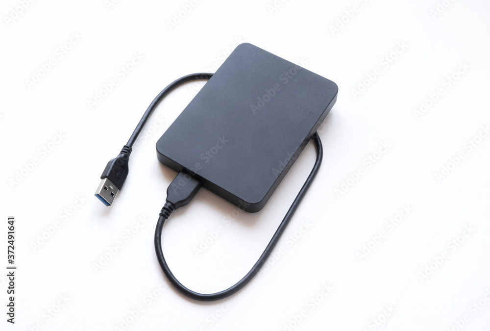 External hard drive top view. Data transfer to external hard drive on white isolated background, space for text External hard drive top view. Data transfer to external hard drive on white isolated background, space for text
