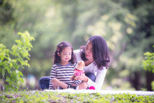 Portrait of happy loving mother and her baby outdoors, Asian girl lifestyle. Asia mother's day concept