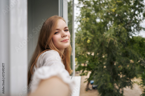 Woman stands on the terrace of the house and takes a selfie Free Download Woman stands on the terrace of the house and takes a selfie - GFXLoad