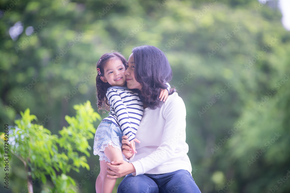 Fototapeta premium Portrait of happy loving mother and her baby outdoors, Asian girl lifestyle. Asia mother's day concept