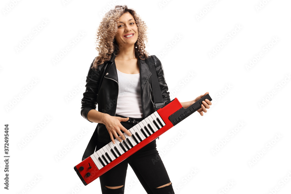 Fototapeta premium Female musician with a curly blond hair playing a keytar synthesizer