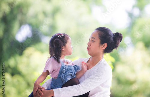 Portrait of happy loving mother and her baby outdoors, Asian girl lifestyle. Asia mother's day concept © NITIKAN T.