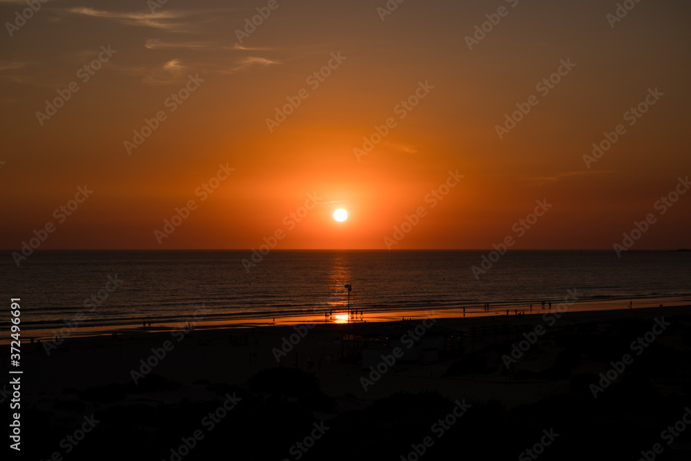 Sunset at La Barrosa beach in Sancti Petri, Cadiz, Spain