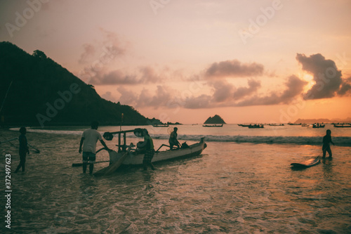 sunset at selong belanak beach , lombok , indonesia. one of the best sunset spot in lombok island. photo