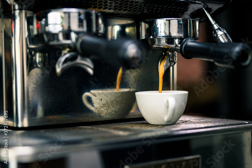 coffee machine mixing espresso shot in glass cup