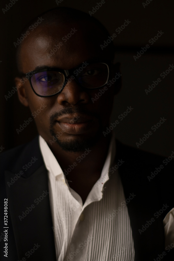 A handsome Black African Man with Glasses poses for a Portrait A handsome Black African Man with Glasses poses for a Portrait