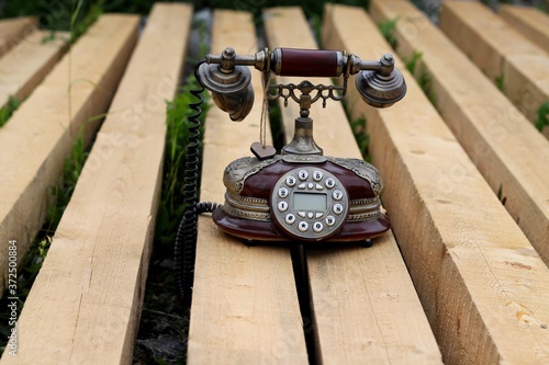 Wallpaper Mural old fashioned phone on the bench Torontodigital.ca