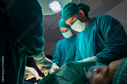 concentrated professional surgical doctor team operating surgery a patient in the operating room at the hospital. healthcare and medical concept.