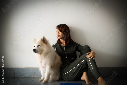 Lady sitting beside her dog with unhappy feeling,stress and upset,blurry light around
