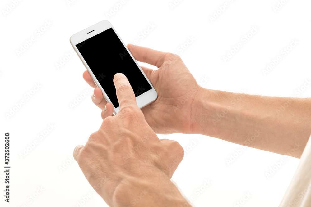 Man holding a smartphone with empty black screen. Mobile phone in a vertical position in hands and isolated on white background. High quality studio shot. Man shows the phone screen to the camera. Man holding a smartphone with empty black screen. Mobile phone in a vertical position in hands and isolated on white background. High quality studio shot. Man shows the phone screen to the camera.