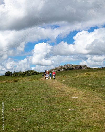 Family walking to the Cheesewring on Stowe's hill Bodmin Moor