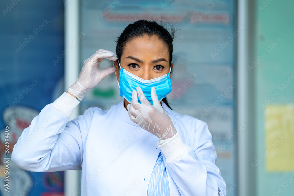 Female doctor wearing protective mask to Protect Against Covid-19,Health care worker in hospital diagnosing patients. Female doctor wearing protective mask to Protect Against Covid-19,Health care worker in hospital diagnosing patients.