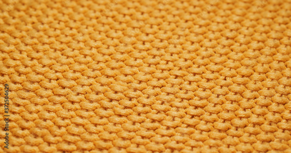 Yellow knitted duvet texture close up Yellow knitted duvet texture close up