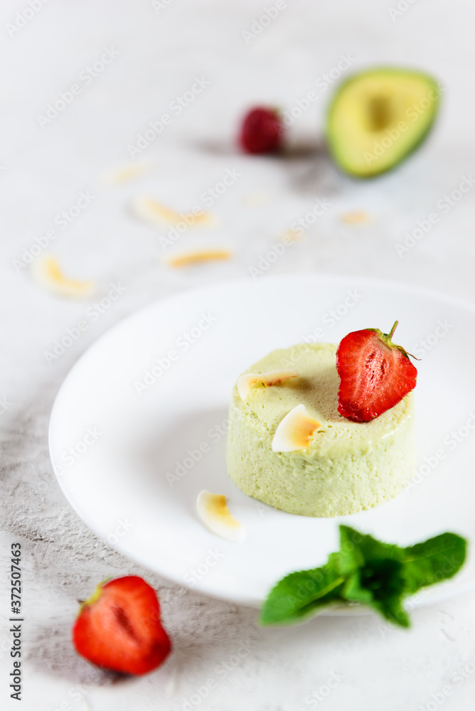 Avocado panna cotta with strawberries, mint and coconut. Sugar, lactose, gluten free. Healthy food, diet, vegetarian. Avocado panna cotta with strawberries, mint and coconut. Sugar, lactose, gluten free. Healthy food, diet, vegetarian.