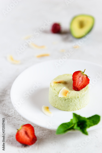Avocado panna cotta with strawberries, mint and coconut. Sugar, lactose, gluten free. Healthy food, diet, vegetarian.
