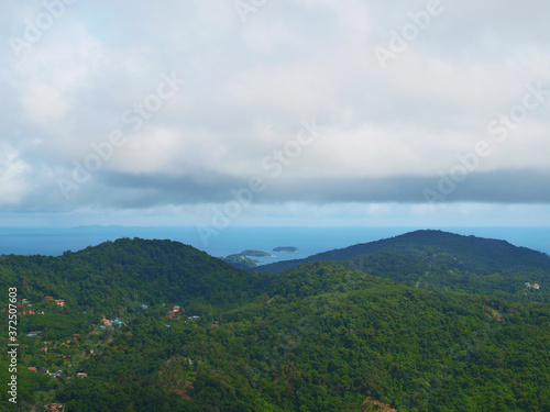 Mountain landscape with clouds. Turquoise sea  a lot of small islands  cloudy sky. Thunderclouds. Two green hills. Panoramic view from the top of green hill. Forest  tropical jungle. Thailand. Phuket
