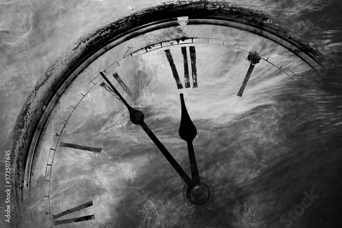 Retro black and white clock with five minutes before twelve