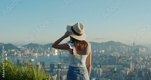 Photography Woman look at the city view on mountain