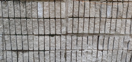 A wall of coarse-textured gray bricks_background