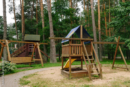 Children's playground. A children's slide made of wood and natural materials.