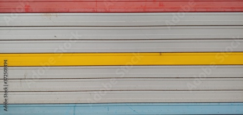 Shutter door_background of garage with red yellow blue line