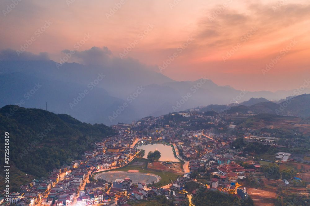 Aerial view of panorama landscape at the hill town in Sapa city, Vietnam with the sunny light and sunset, mountain view in the clouds - obrazy, fototapety, plakaty 