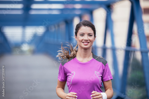 Happy athletic woman running in nature in the morning. Young woman training outdoors.. Free Download Happy athletic woman running in nature in the morning. Young woman training outdoors.. - GFXLoad