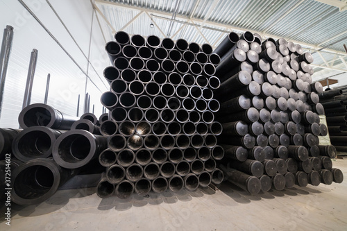 Black plastic tubes in the manufacturing storage