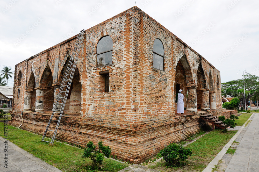 PATTANI, THAILAND -JULY 10, 2014: Historic Kru Se mosque which is made of bricks with round pillars. The mosque represents a unique Islamic civilization of the Kingdom of Pattani in Thailand.